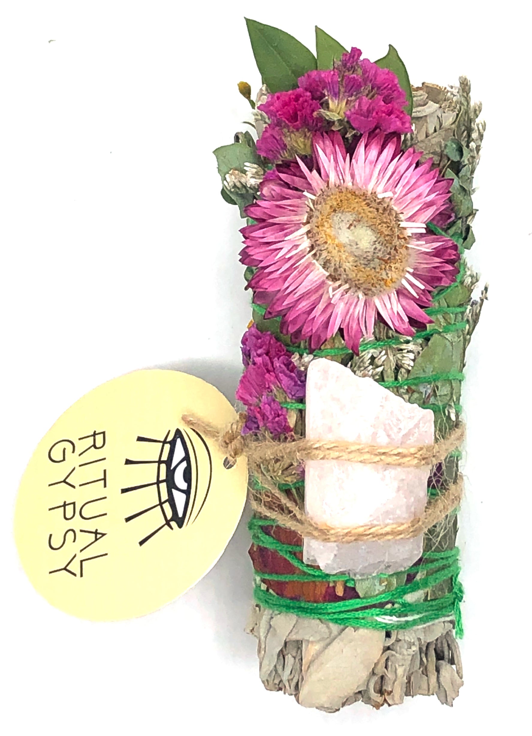 small white sage smoke cleansing smudge bundle with pink statice and pink strawflower wrapped in florals with rose quartz and round product tag saying ritual gypsy attached