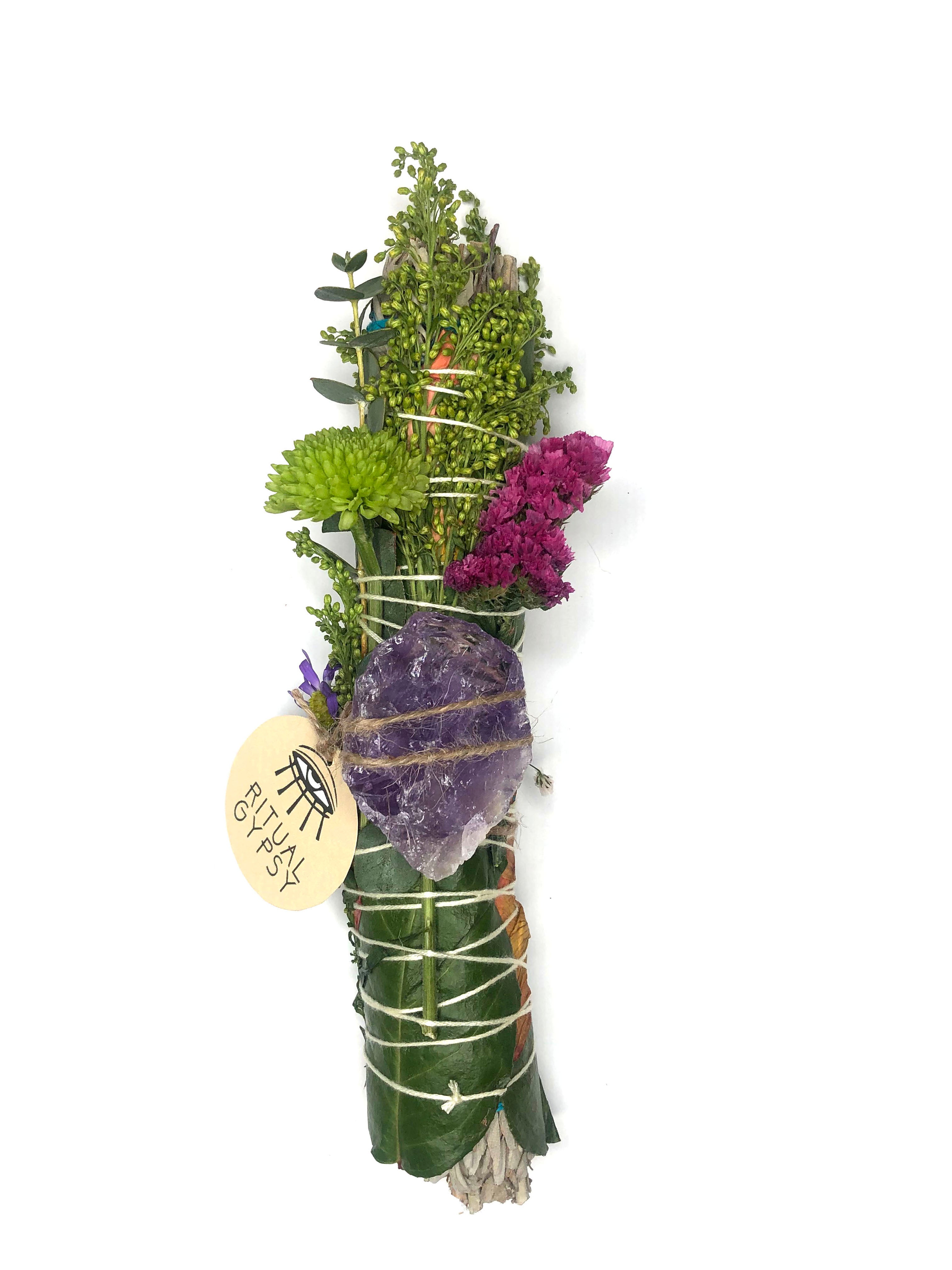 9" large white sage smoke cleansing smudge bundles with pink and purple statice and pink strawflower wrapped in florals with amethyst crystal and round product tag saying ritual gypsy attached
