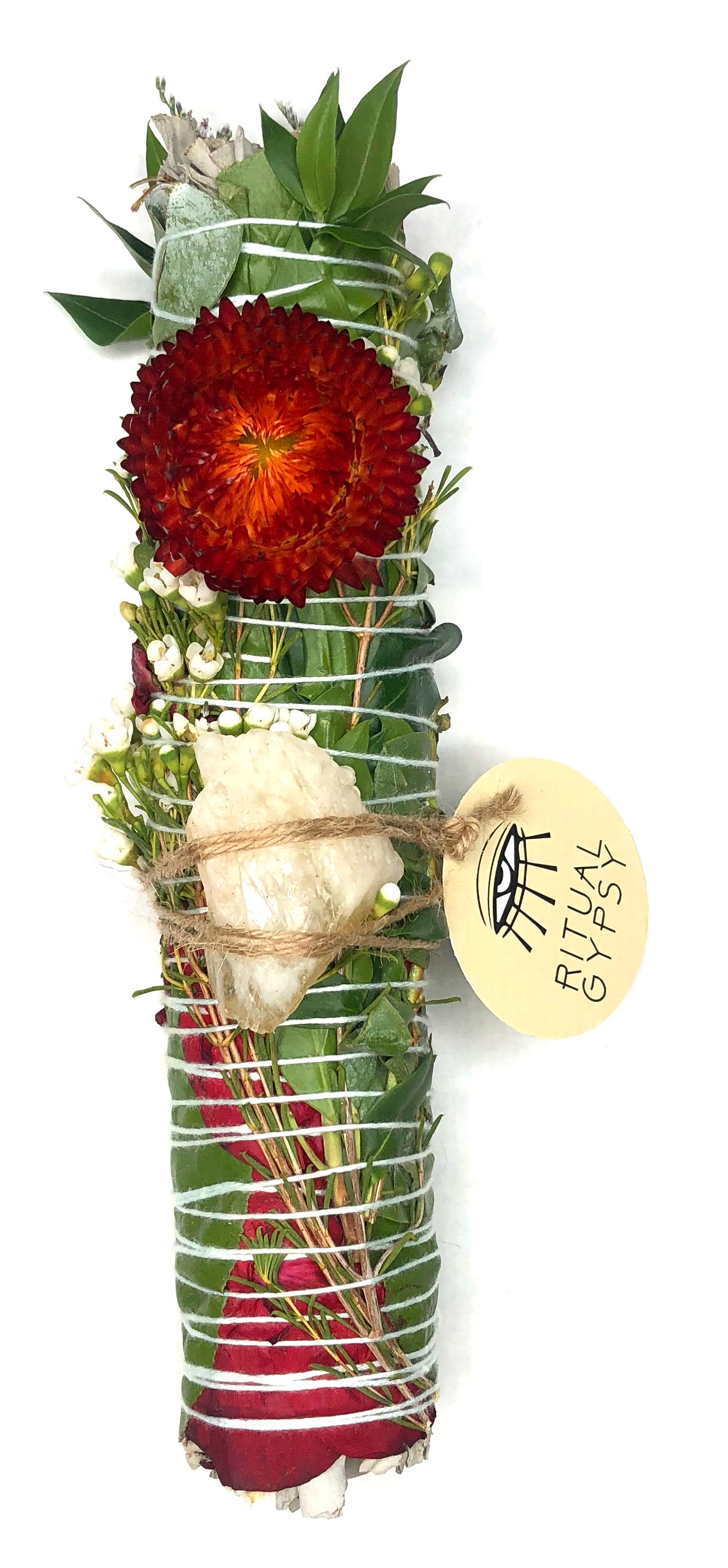 white sage smoke cleansing smudge bundle wrapped in florals with orange red strawflower and orange brown gray desert jasper crystal and round ritual gypsy product tag attached on white background