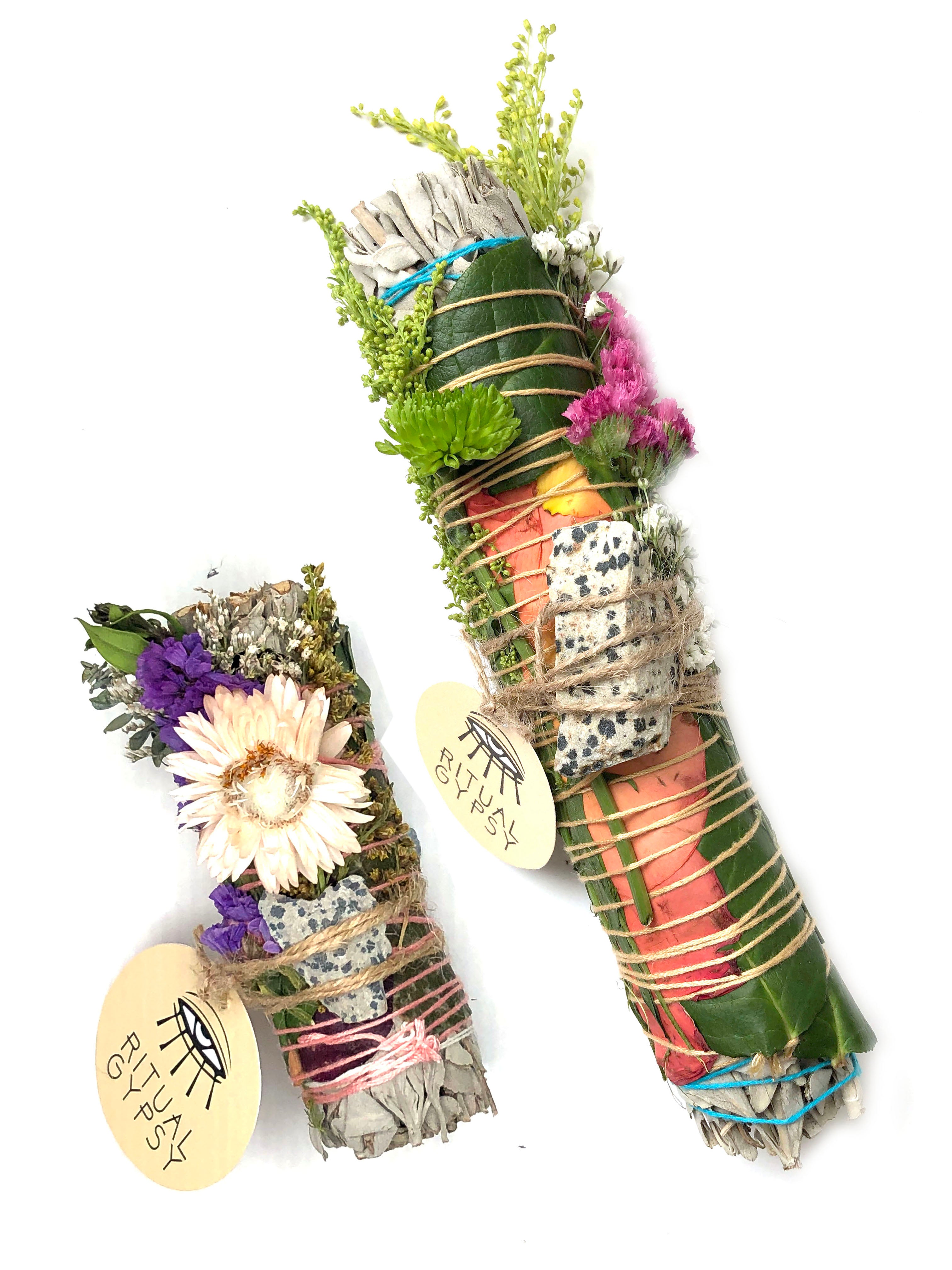 white sage smoke cleansing smudge bundle wrapped in red and yellow rose petals, strawflowers and florals with white with dark blue spots dalmatian jasper stone crystal and round ritual gypsy product tag on white background