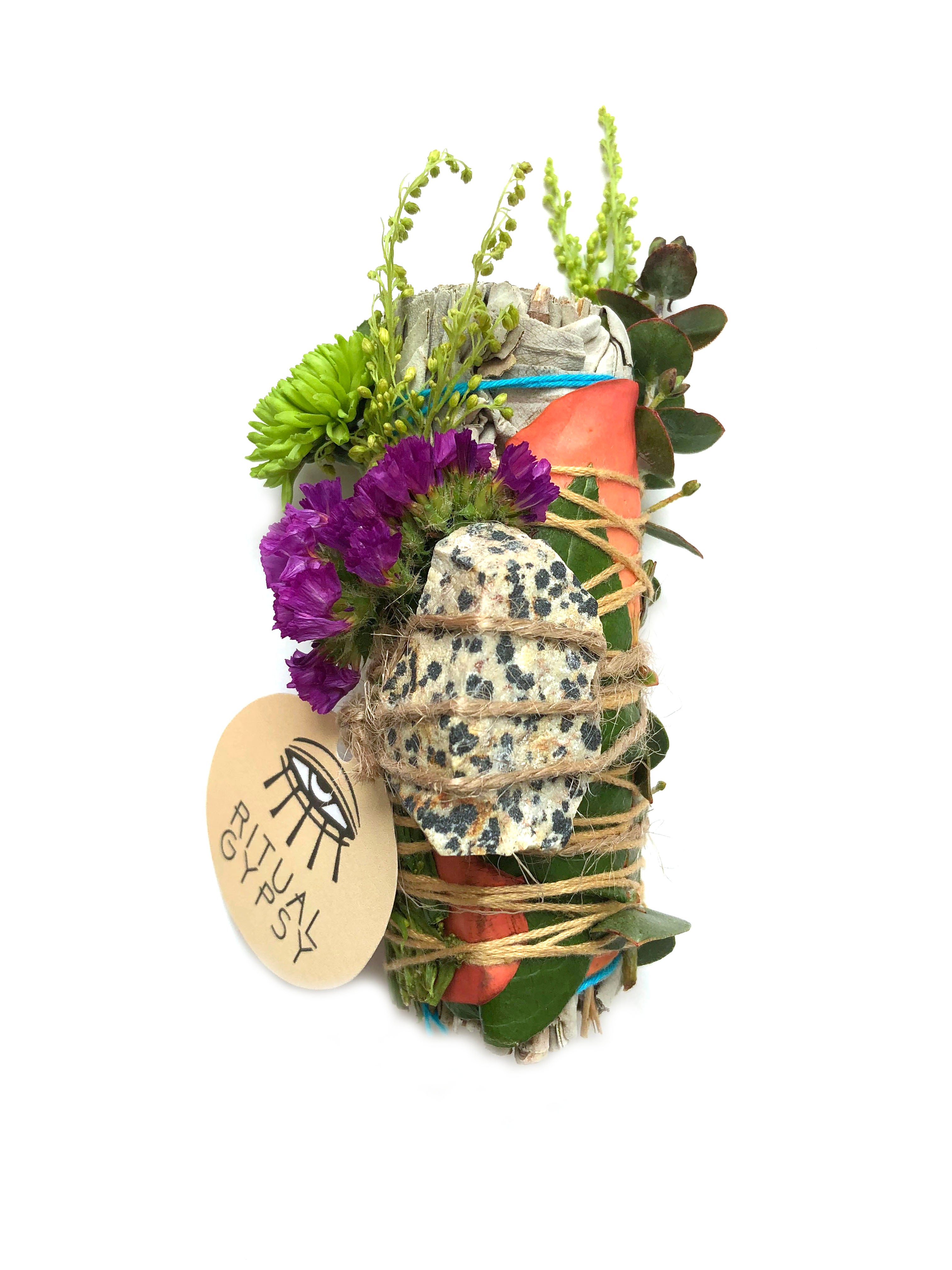white sage smoke cleansing smudge bundle wrapped in red and yellow rose petals, strawflowers and florals with white with dark blue spots dalmatian jasper stone crystal and round ritual gypsy product tag on white background