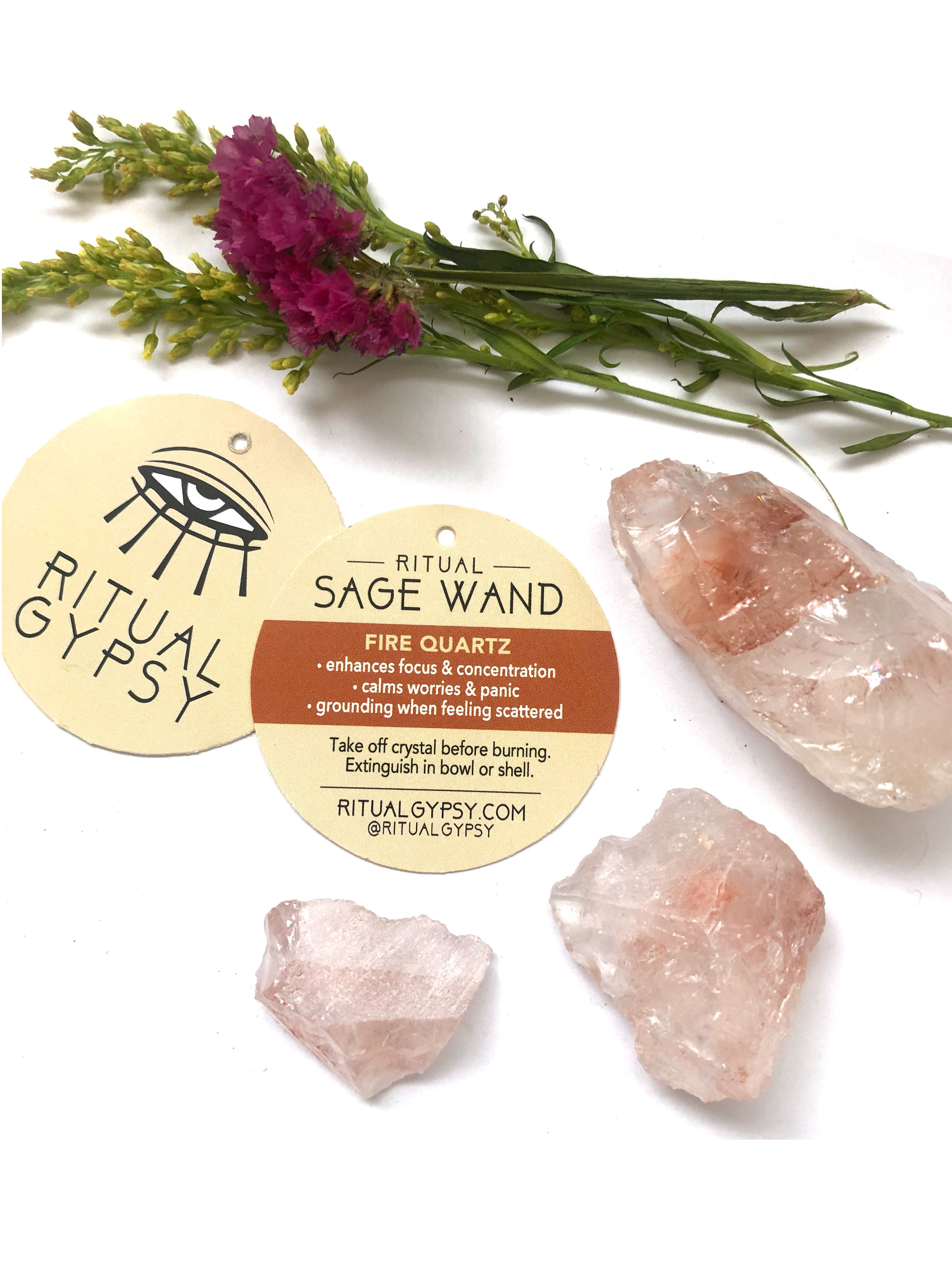 3 pink fire quartz crystals and round ritual gypsy product tags on white surface