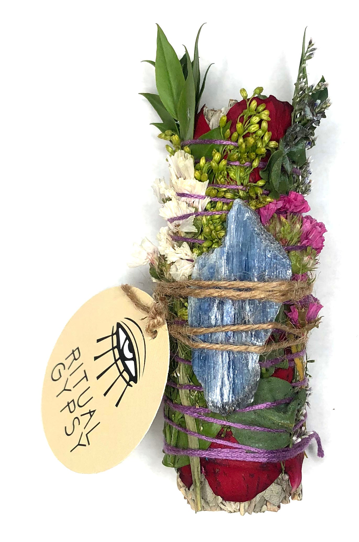 white sage smoke cleansing smudge bundle wrapped in florals with red strawflower and blue kyanite blade crystal and round ritual gypsy product tag attached on white background