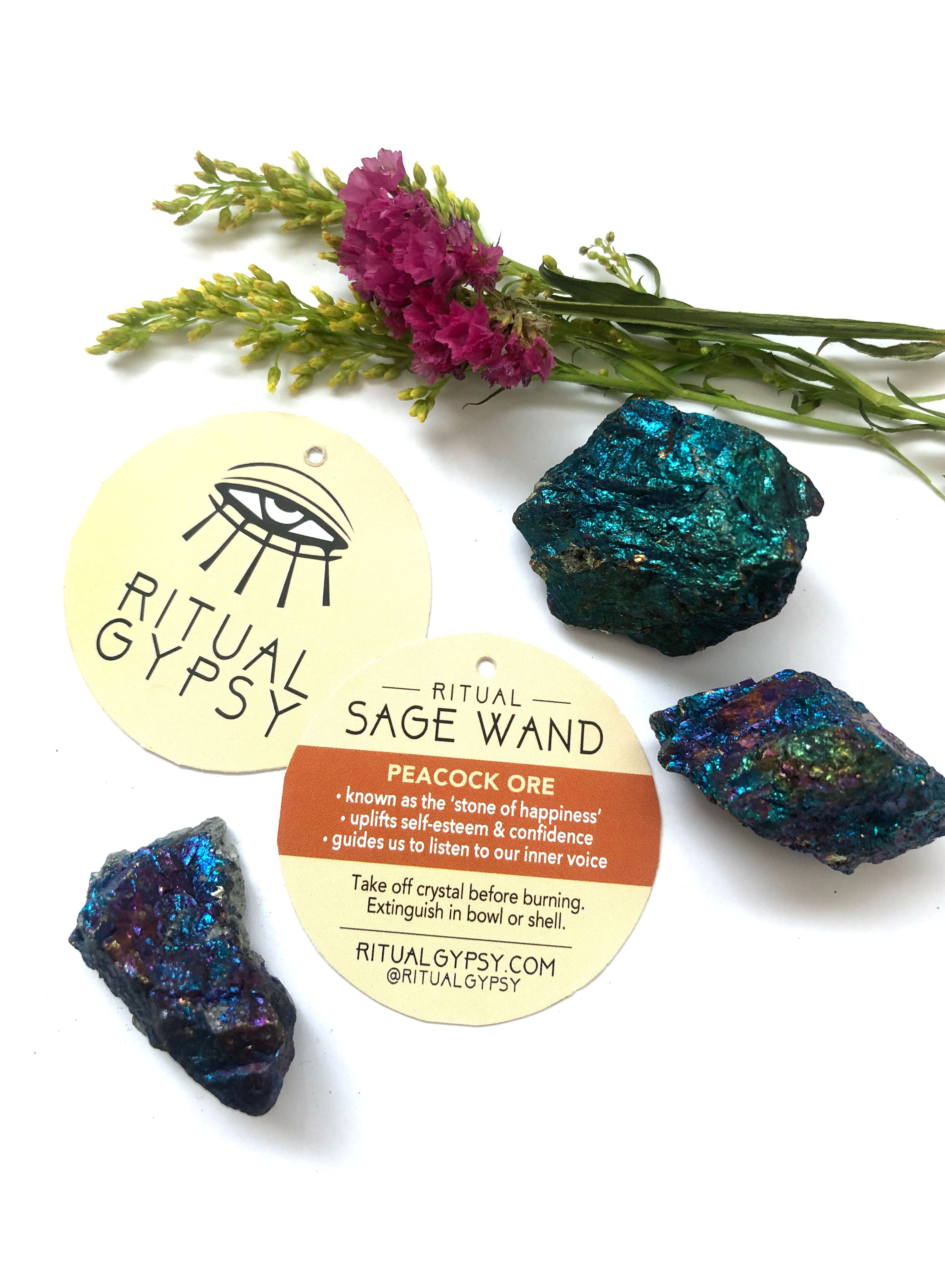 3 blue purple shiny peacock ore crystals with round ritual gypsy product tag on white surface