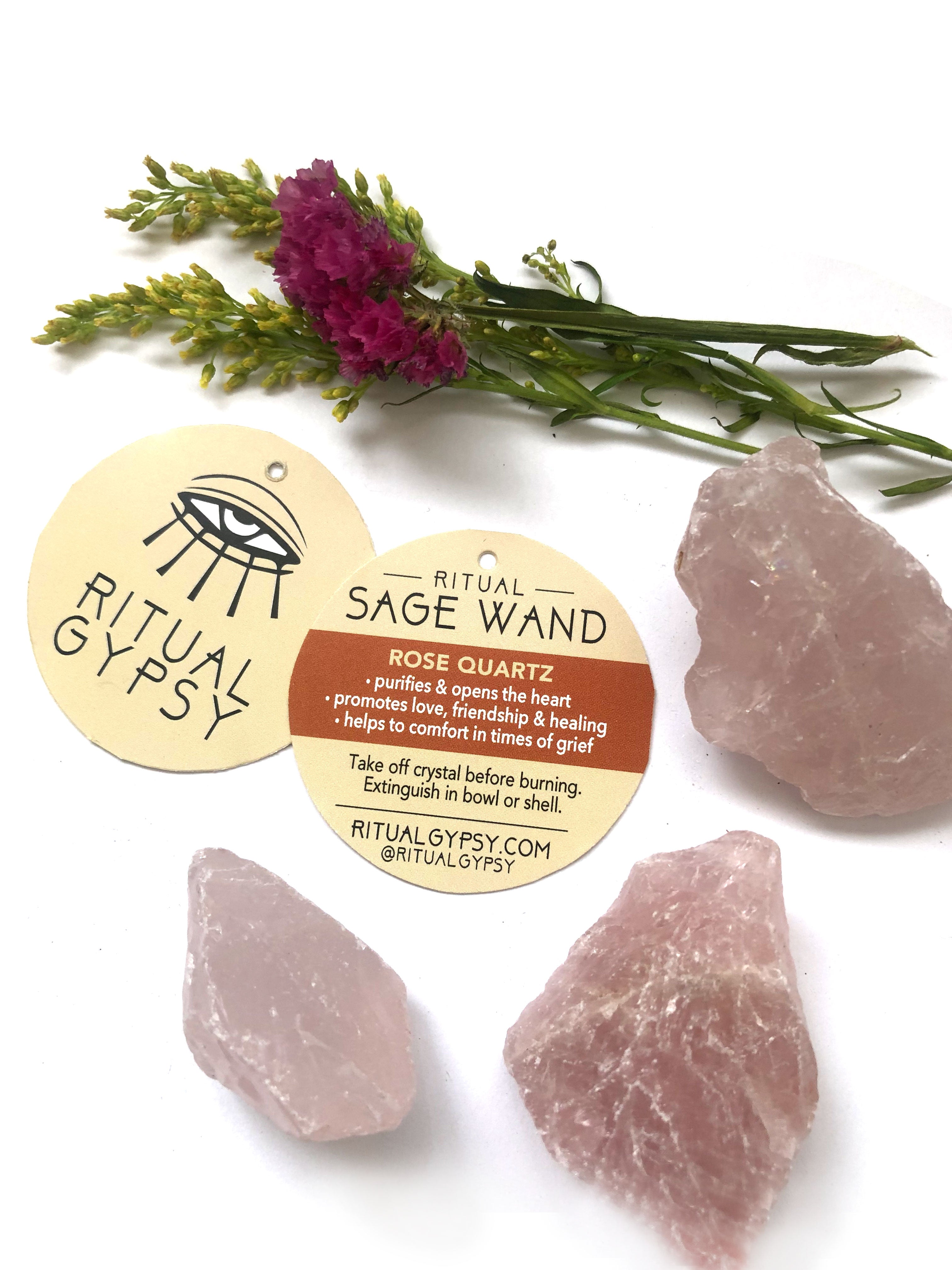 3 rose quartz crystals on a white surface next to a round cream color product tag with ritual gypsy on it