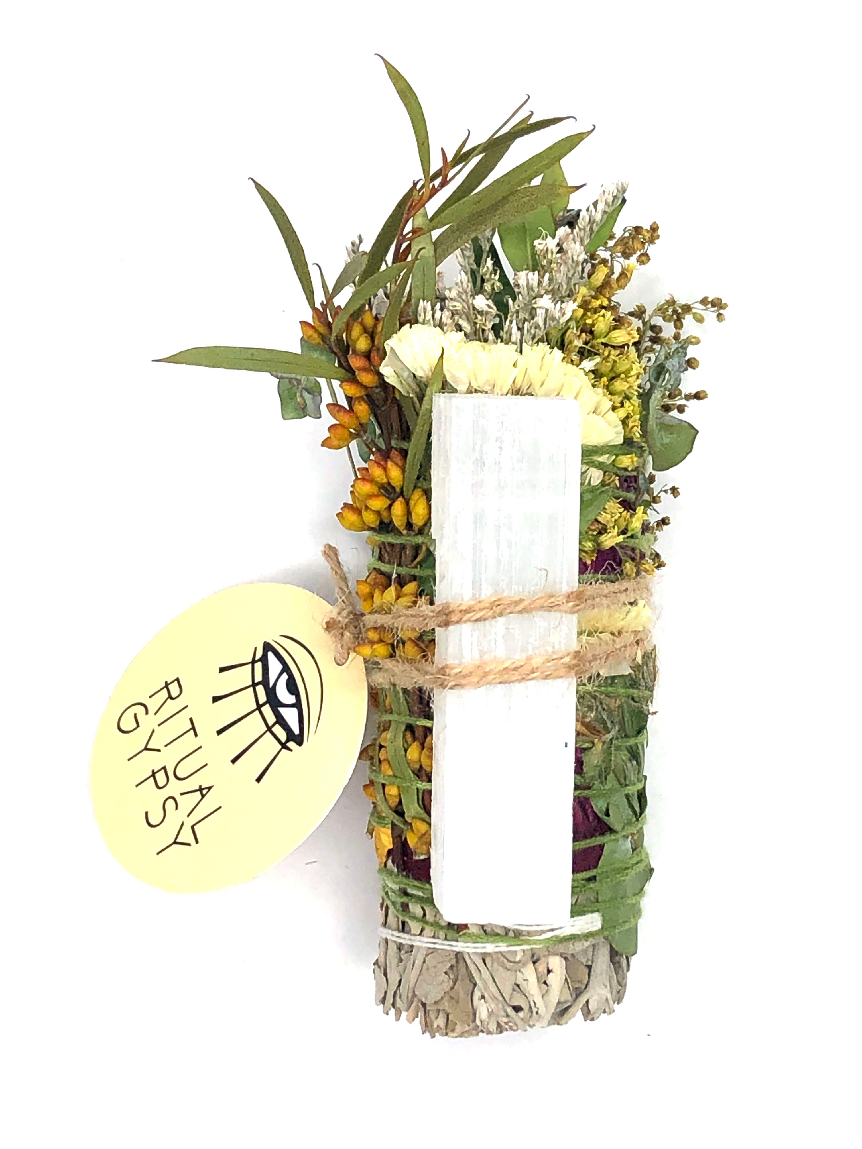 4" small white sage smoke cleansing smudge bundles with pink and purple statice and pink strawflower wrapped in florals with white selenite crystal and round product tag saying ritual gypsy attached